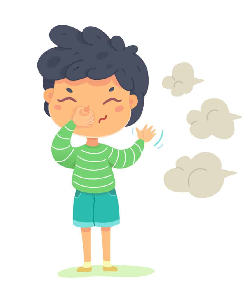 
Boy sniffing bad smell and closing nose with hand. Small child standing in nature and smelling disgusting smell.